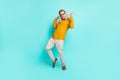 Full size photo of young handsome man have fun dance party enjoy excited isolated over turquoise color background Royalty Free Stock Photo