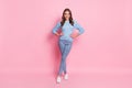 Full size photo of young happy cheerful good mood smiling girl wear blue sweater and jeans isolated on pink color