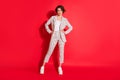 Full size photo of young happy positive confident attractive businesswoman wear checkered suit isolated on red color Royalty Free Stock Photo