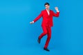 Full size photo of young man happy positive smile have fun dance party  over blue color background Royalty Free Stock Photo