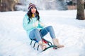 Full size photo of young pretty charming excited funky funny girl riding sledge having fun winter holiday vacation