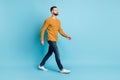 Full size photo of young serious cool attractive handsome man go walk look copyspace isolated on blue color background Royalty Free Stock Photo