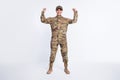 Full size photo of young woman soldier officer army show hand biceps power strong isolated over white color background Royalty Free Stock Photo