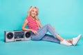 Full size photoof cheerful happy woman sit floor good mood boombox isolated on pastel teal color background