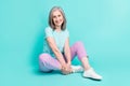 Full size picture of gorgeous cheerful lovely mature woman sit floor enjoying summer weekend isolated on teal color