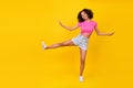 Full size portrait of carefree crazy person raise one leg enjoy free time dance isolated on yellow color background Royalty Free Stock Photo