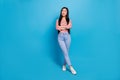 Full size portrait of minded charming thai girl crossed arms look interested empty space ad isolated on blue color Royalty Free Stock Photo