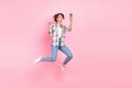 Full size portrait of pretty carefree girl jumping hold smart phone make selfie demonstrate v-sign isolated on pink Royalty Free Stock Photo