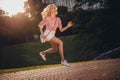 Full size profile photo of attractive cheerful lady jump run hurry fast street outside Royalty Free Stock Photo