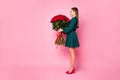 Full size profile photo of attractive lady model hold large one hundred roses bunch smelling amazing aroma wear green Royalty Free Stock Photo