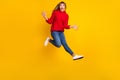 Full size profile photo of blond optimistic lady jump yell wear red sweater jeans sneakers isolated on bright yellow Royalty Free Stock Photo