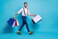 Full size profile photo of handsome business man carry many bags buy vacation stuff shopping center store good mood wear Royalty Free Stock Photo