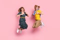 Full size profile photo of optimistic funny couple jump show thumb up wear colorful clothes isolated on pastel pink Royalty Free Stock Photo