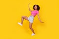 Full size profile photo of positive crazy girl have good mood sneaky walk isolated on yellow color background