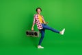 Full size profile photo of pretty funky lady dancing hold boombox wear jeans shirt sneakers on green background