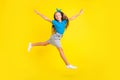 Full size profile portrait of active carefree girl arms wings flight jumping isolated on yellow color background