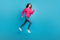 Full size profile portrait of pretty lady running jump empty space toothy smile isolated on blue color background Royalty Free Stock Photo