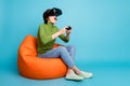 Full size profile side photo of amazed girl play video game have virtual goggles watch vr reality wear green sweater