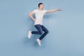 Full size profile side photo of excited man jumping fly air superhero isolated over blue color background Royalty Free Stock Photo