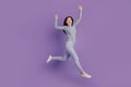 Full size profile side photo of young girl rejoice victory jump up success over purple color background