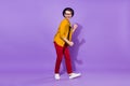 Full size profile side photo of young man happy positive smile have fun dance isolated over purple color background Royalty Free Stock Photo
