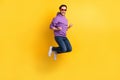 Full size profile side photo of young man happy positive smile rejoice victory jump isolated over yellow color