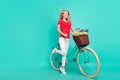 Full size profile side photo of young woman happy smile travel bicycle look empty space isolated over turquoise color Royalty Free Stock Photo