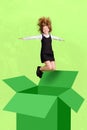 Full size vertical composite picture of delighted school girl jump out box fly isolated on drawing green background