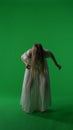 Full-size vertical green screen, chroma key shot of a posessed female, woman figure, ghost, poltergeist, zombie moving