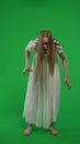 Full-size vertical green screen, chroma key shot of a posessed female, woman figure, ghost, poltergeist, zombie moving