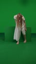 Full-size vertical green screen, chroma key shot of a posessed female, woman figure, ghost, poltergeist, zombie moving