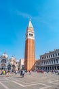 Full size view of Campanile Bell Tower at San Marco square in Venice, Italy, at sunny day, deep blue sky and many tourists Royalty Free Stock Photo