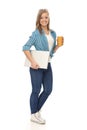 Full size young woman with laptop and coffee