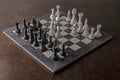 Full sized black and white marble chess board and pieces