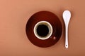 Full small brown cup of black coffee on parchment Royalty Free Stock Photo