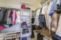 Full small walk in closet with baskets and vault inside