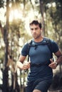 Full steam ahead on his hike. a handsome young man running during his hike in the mountains.