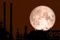 Full Strawberry Moon back on silhouette refinery on night sky Royalty Free Stock Photo