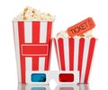 Full striped box with popcorn, movie ticket and 3D glasses isolated on a white Royalty Free Stock Photo