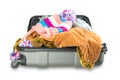 Full suitcase with clothes on white background. Royalty Free Stock Photo