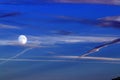 Full supermoon in dramatic blue sky and clouds