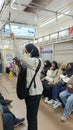 full train passengers standing holding handgrips