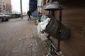 full trash bin with plastic bottles and dirt around on a city stree Royalty Free Stock Photo