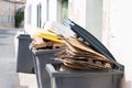 Full trash can of cardboard in street city Royalty Free Stock Photo