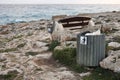 Full trash or litter bin with plastic bottle, beer can and organic waste visibile showing pollution in coastal areas near the sea Royalty Free Stock Photo