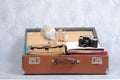 Full travel suitcase on grey background, opened case with travel clothing and accessories. Royalty Free Stock Photo