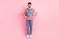 Full unhappy upset sullen man hold hands waist pose bad mood isolated on pastel pink color background Royalty Free Stock Photo