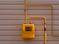 A full view of residential urban natural gas meter measuring gas consumption, outside house gas meter in yellow box Royalty Free Stock Photo