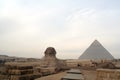 View of the Sphinx With the Great Pyramid in Background on The Giza Complex Royalty Free Stock Photo