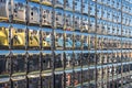 A full wall of gleaming, metallic post office boxes featuring individual locks and numbering. Reflective surfaces in an indoor Royalty Free Stock Photo